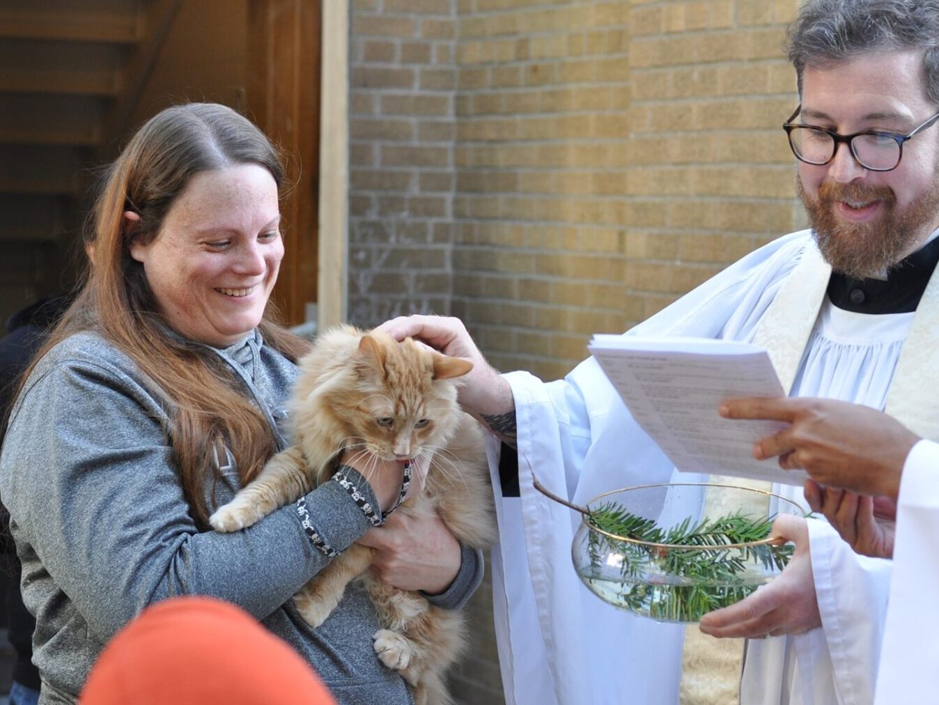 A person holding a cat at the Blessing of the Animals