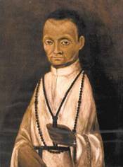 A painting of St. Martin de Porres, a mixed-race man of Spanish, African, and Native South American descent. He is wearing a rosary and a Dominican monk's habit.